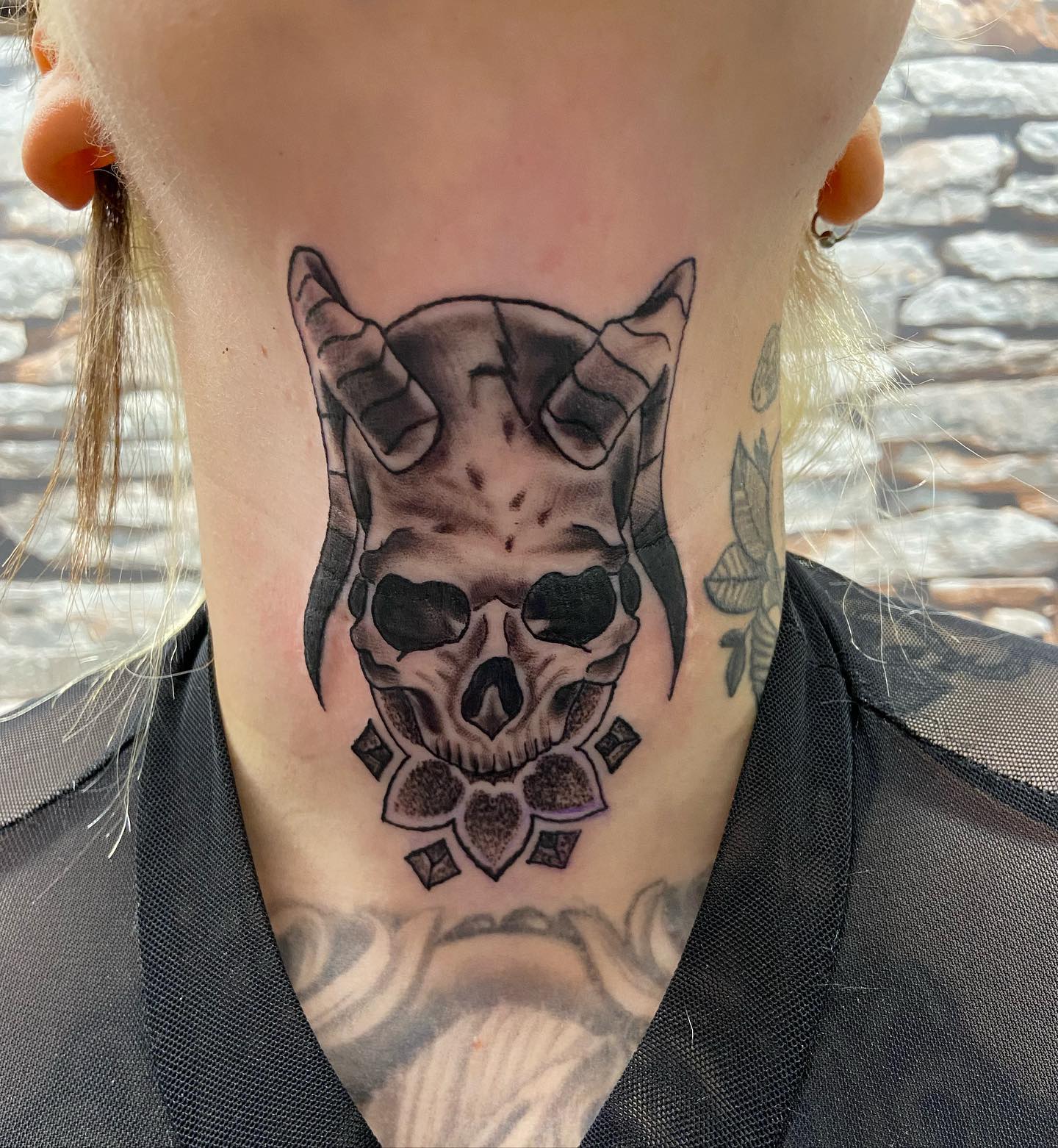 Skull tattoos can be a great companion on your body if you like creepy designs. In this tattoo, a horned black skull is combined with nicely done shadow details and lines. Those who love this kind of skull tattoos should definitely try this tattoo out.