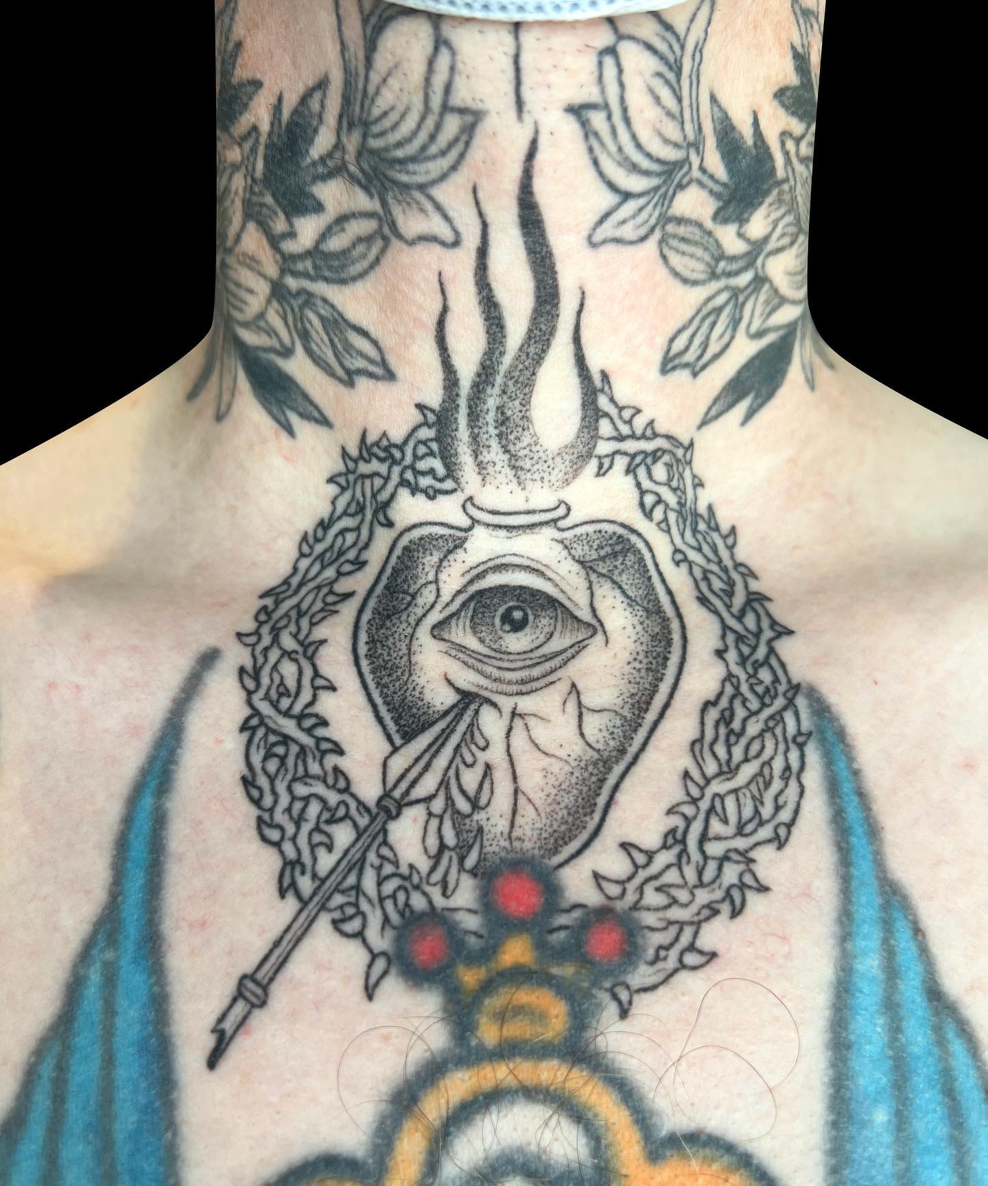 Here is an ablazed vase with a single eye, which is fractured by a spear. It's a very interesting tattoo and the meaning of it can change from person to person. For us, it represents patience and toleration.