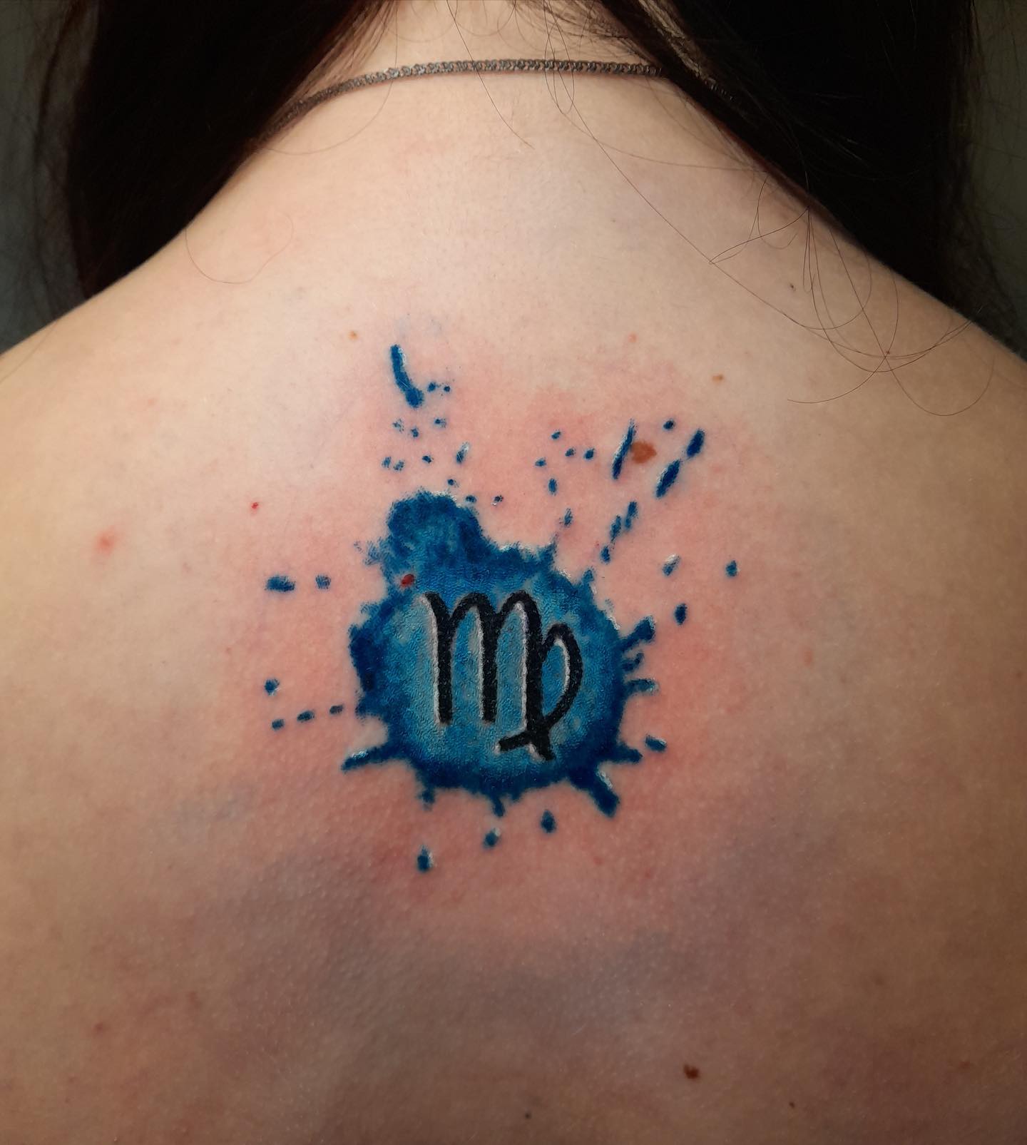 A Virgo tattoo adorned with blue splash effect could be an interesting design to have on your body. Go for it if you like creative tattoos.
