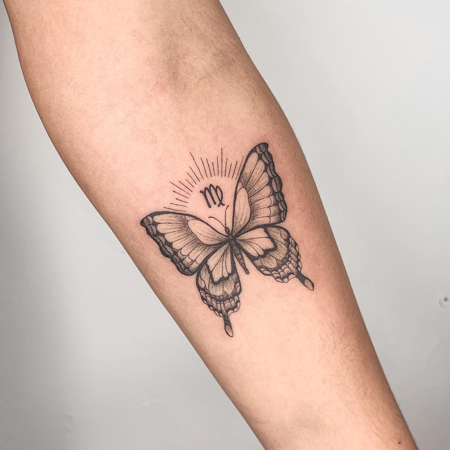 Your zodiac sign is harmonized with a detailed butterfly like the one above. It's a perfect choice for those who can't give up on having a butterfly tattoo.