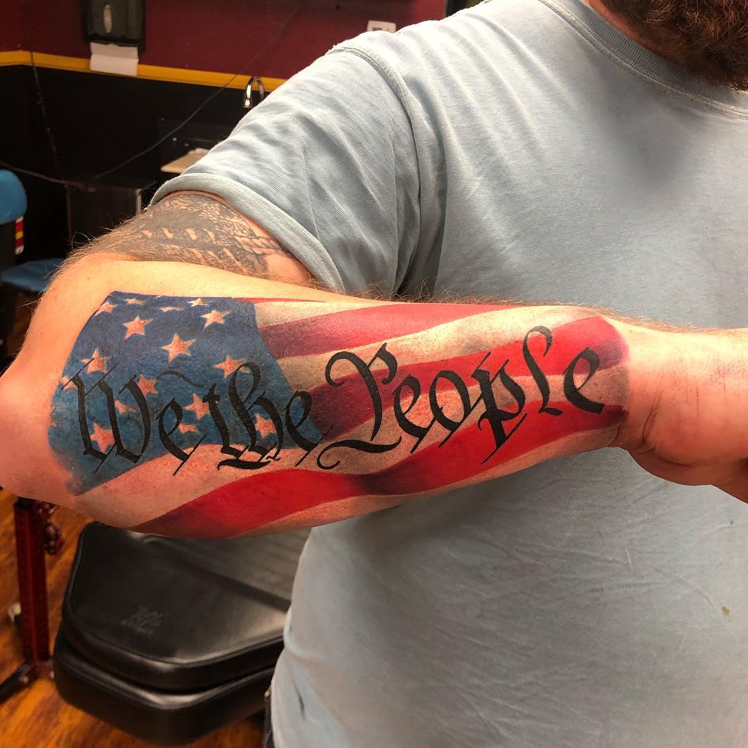 The tattoo We The People from the United States Constitution decorates  the arm of Trump supporter Bob Lewis left as he argues with counter  protester Ralph Gaines as Trump supporters demonstrate against