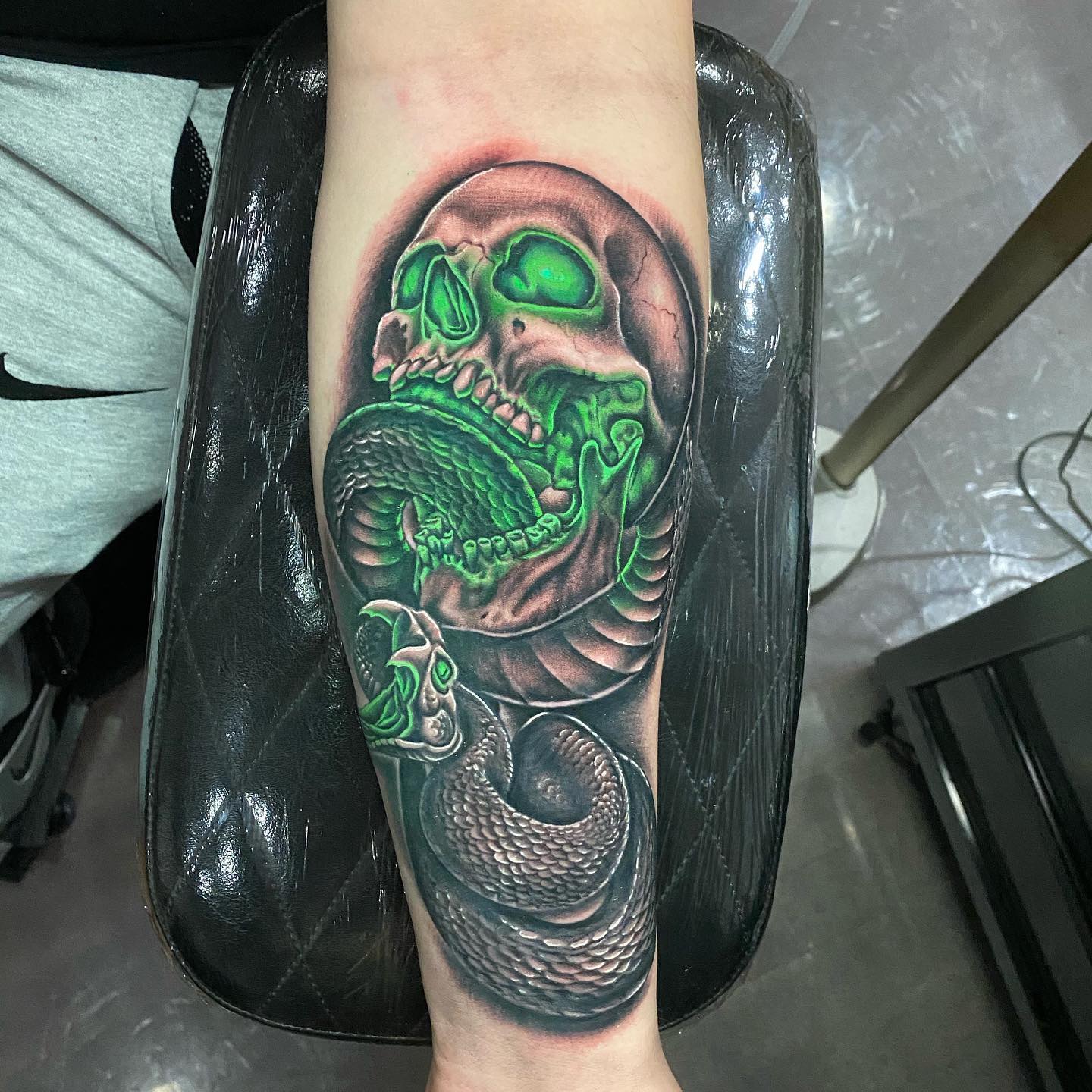 Doesn't it look so real? It feels like the snake will come out of the body and bite! If you wanna get a highly detailed and real-like death eater tattoo, go for this with some green light effect.