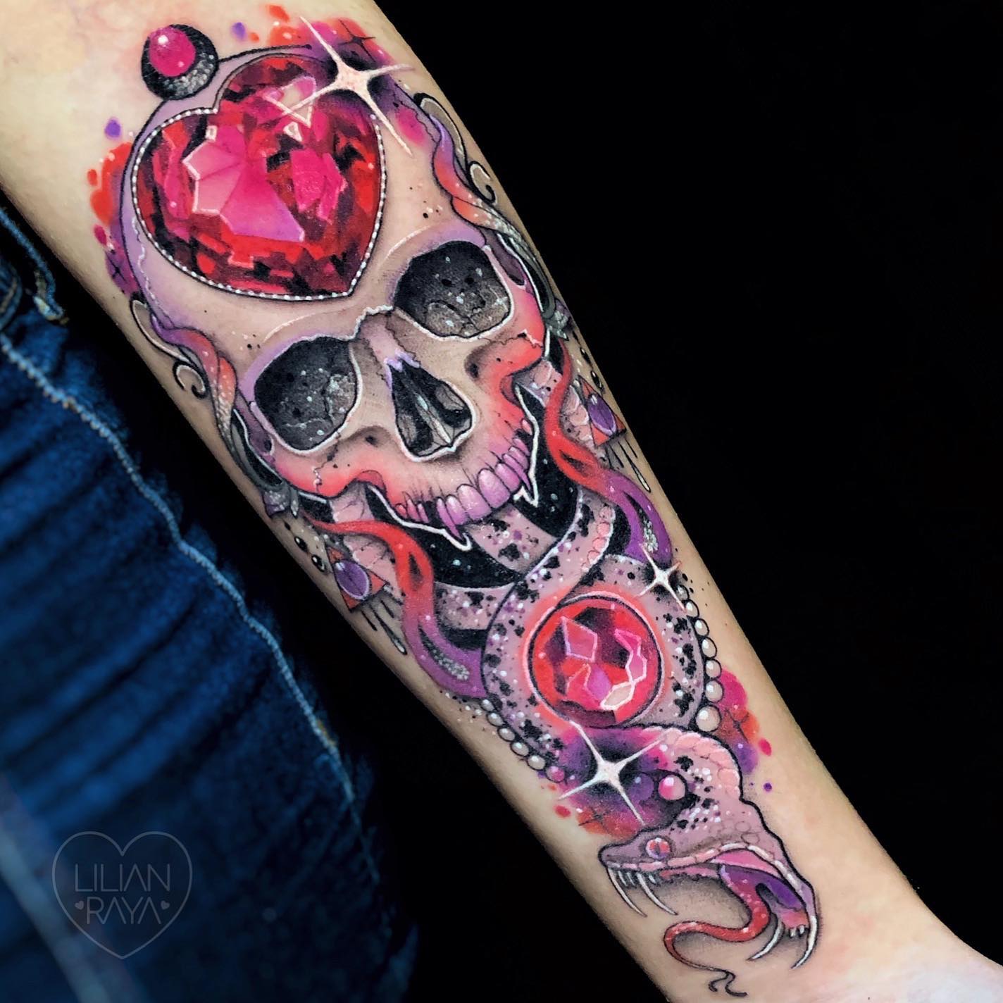 Wanna have a death eater tattoo that is so unique that only a few people have it? Then, go for a pink and purple one. The colors are not the only things that make this tattoo aesthetic big shiny stones are the final touch.