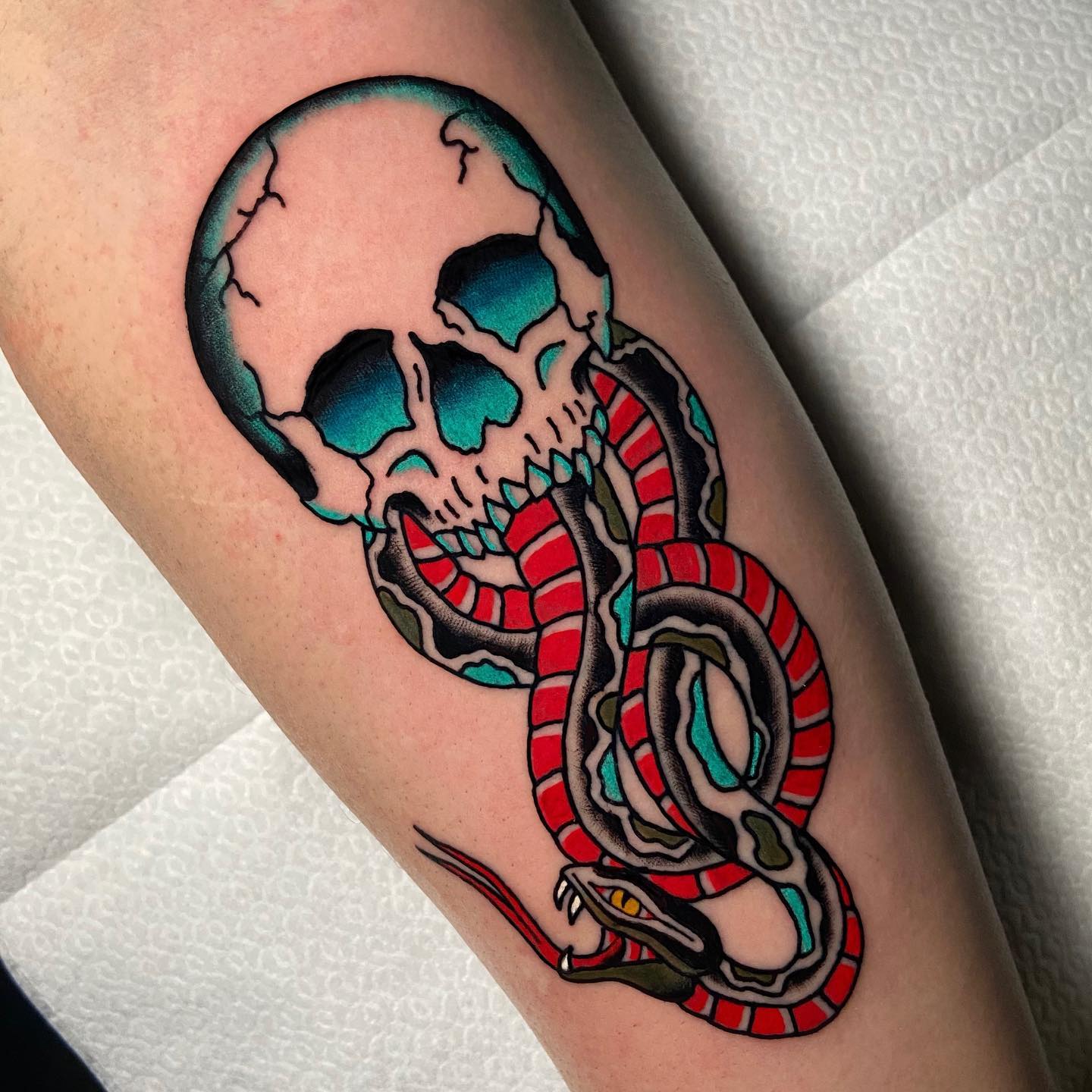 Traditional death eater tattoos are usually black and white, but blue and red colors are used in this example to give it a great look. It is done in a tribal style, but sometimes this type of tattoos can be more fluid or have more of an abstract feel.