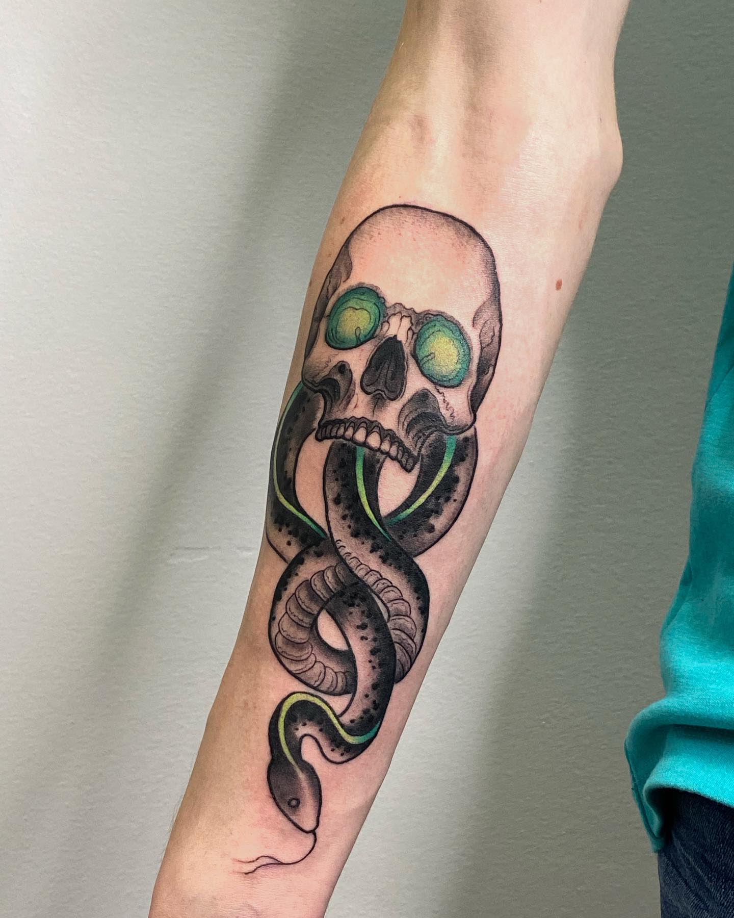 Being a tattoo that represents the death eaters' love for Voldemort, and their willingness to die for him, this one rocks. The green line which comes down from the skull's eyeballs to the snake's body adds a great detail to the whole picture.