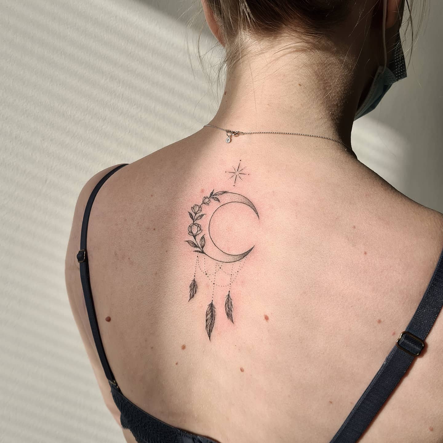The tattoo has flowers around the edges of the dreamcatcher, with a moon in the center of it. This floral moon dream catcher is a great way to get a little bit of nature in your life. It's a symbol of balance and peace, which are the things we all need more of.