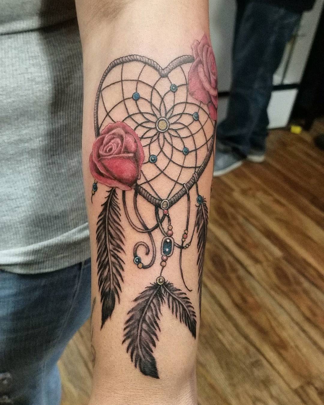 A red rose tattoo is a popular choice for many people. Red roses stand for passion and love, and they are often used to show appreciation. So, let's show your love of dreamcatchers with this tattoo design.