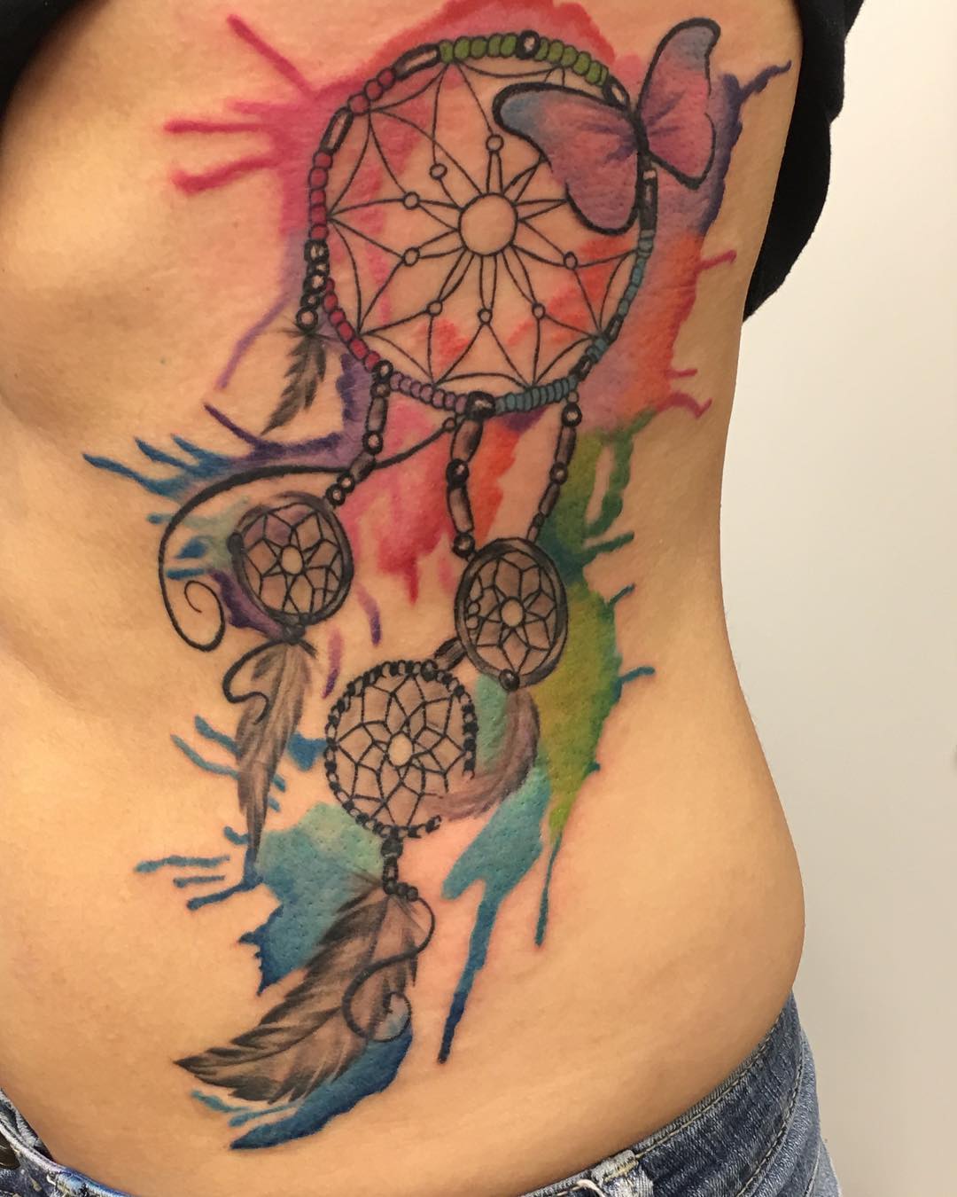 Watercolor dream catcher tattoo is a tattoo that has watercolor effect. The main idea behind this kind of tattoo is to make it look like it was painted on your skin with watercolors. Typically, they are very colorful and have a lot of details, which makes them quite interesting.