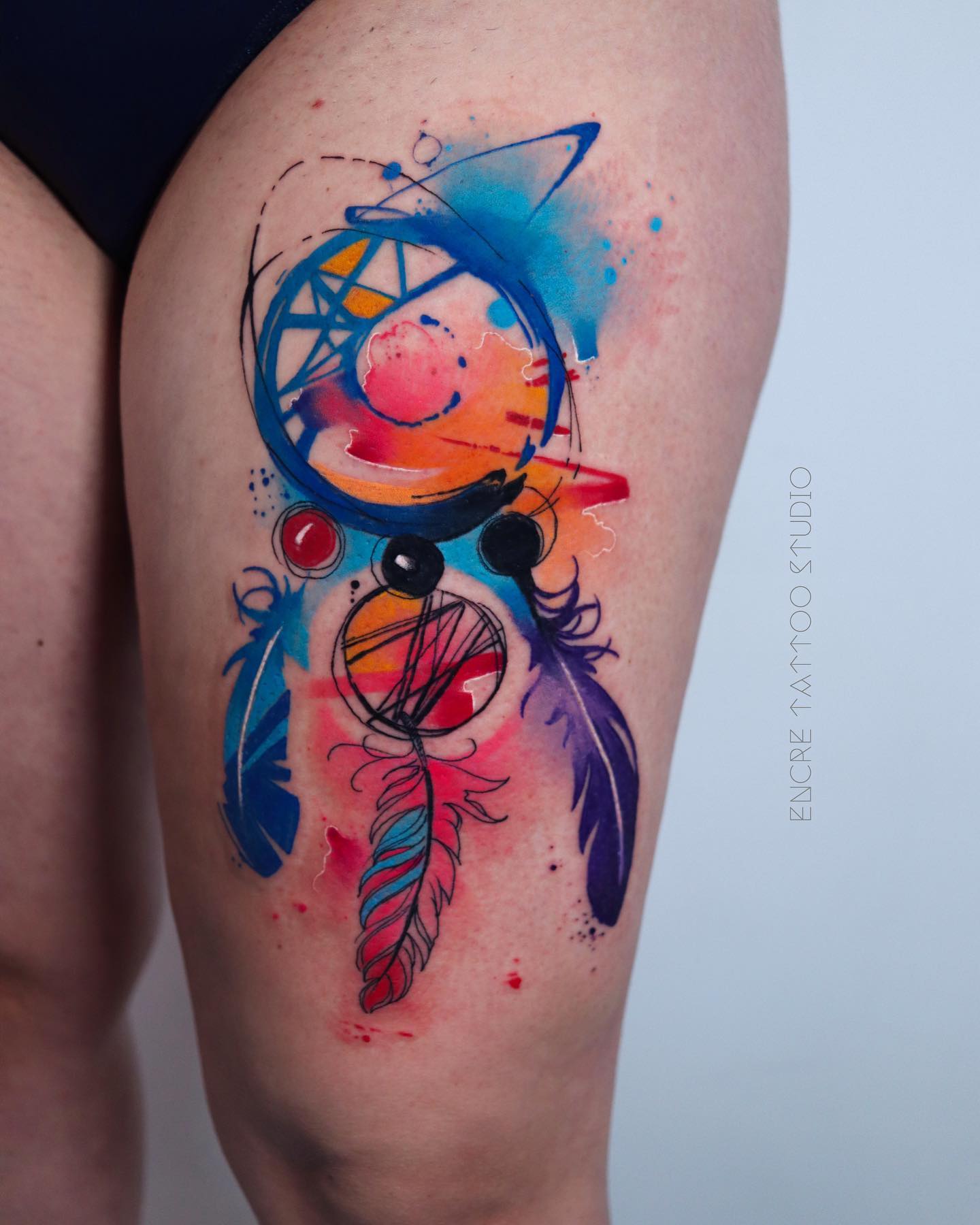 The dream catcher is a Native American symbol that represents protection and peace. Because of its strong symbolism, you should get it. A colorful and abstract dream catcher tattoo on the upper leg offers a very beautiful and feminine look.