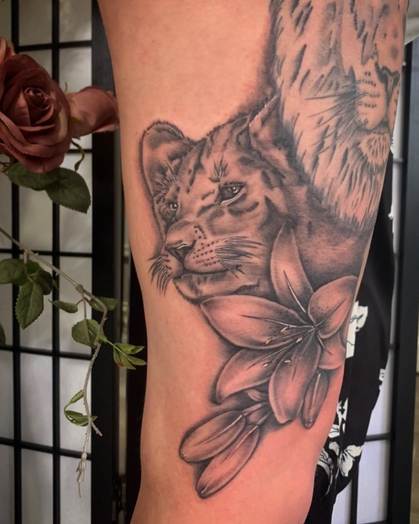 Lion and its cub tattoos are one of the most popular tattoo designs that symbolize strength, power and protection. When a lily is added below them, the love and affection between these two prevail.