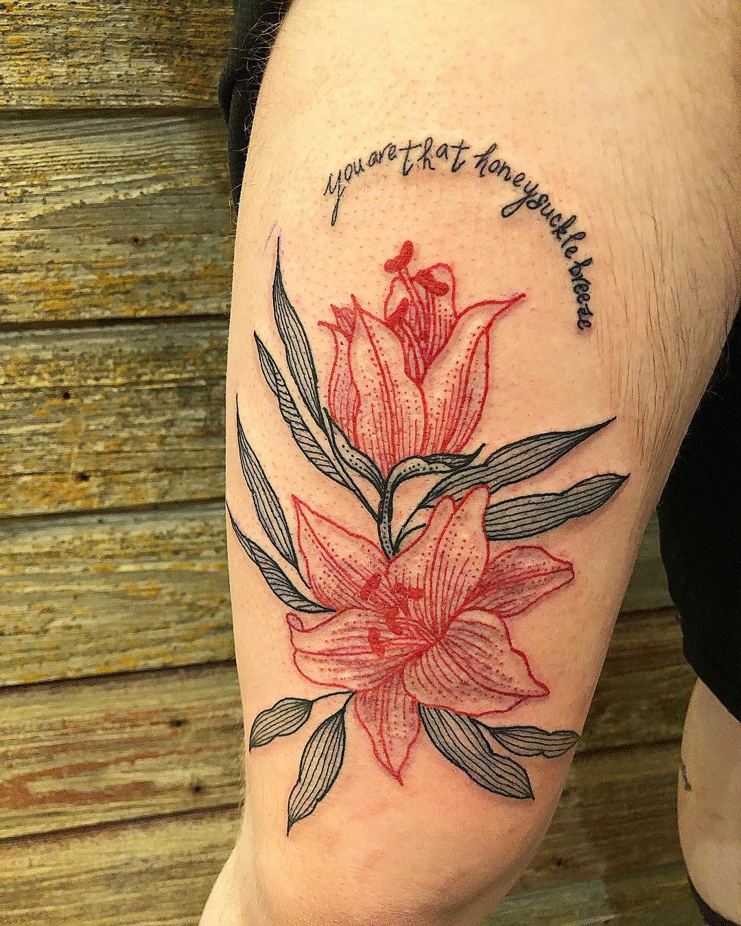 Let's combine red and black colors in a lily tattoo to show everyone that you have a good taste. When you mix them in one tattoo, it becomes a symbol of courage and strength. In order to stand out from the crowd easily, let's cover your upper leg with a red lily and black leaves.
