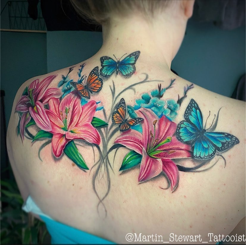 A tattoo of pink lilies and blue butterflies on back is a really interesting one. The combination of these two creates a great meaning. Blue butterflies symbolize a person's essence and rebirth while pink lilies symbolize loyalty and love.