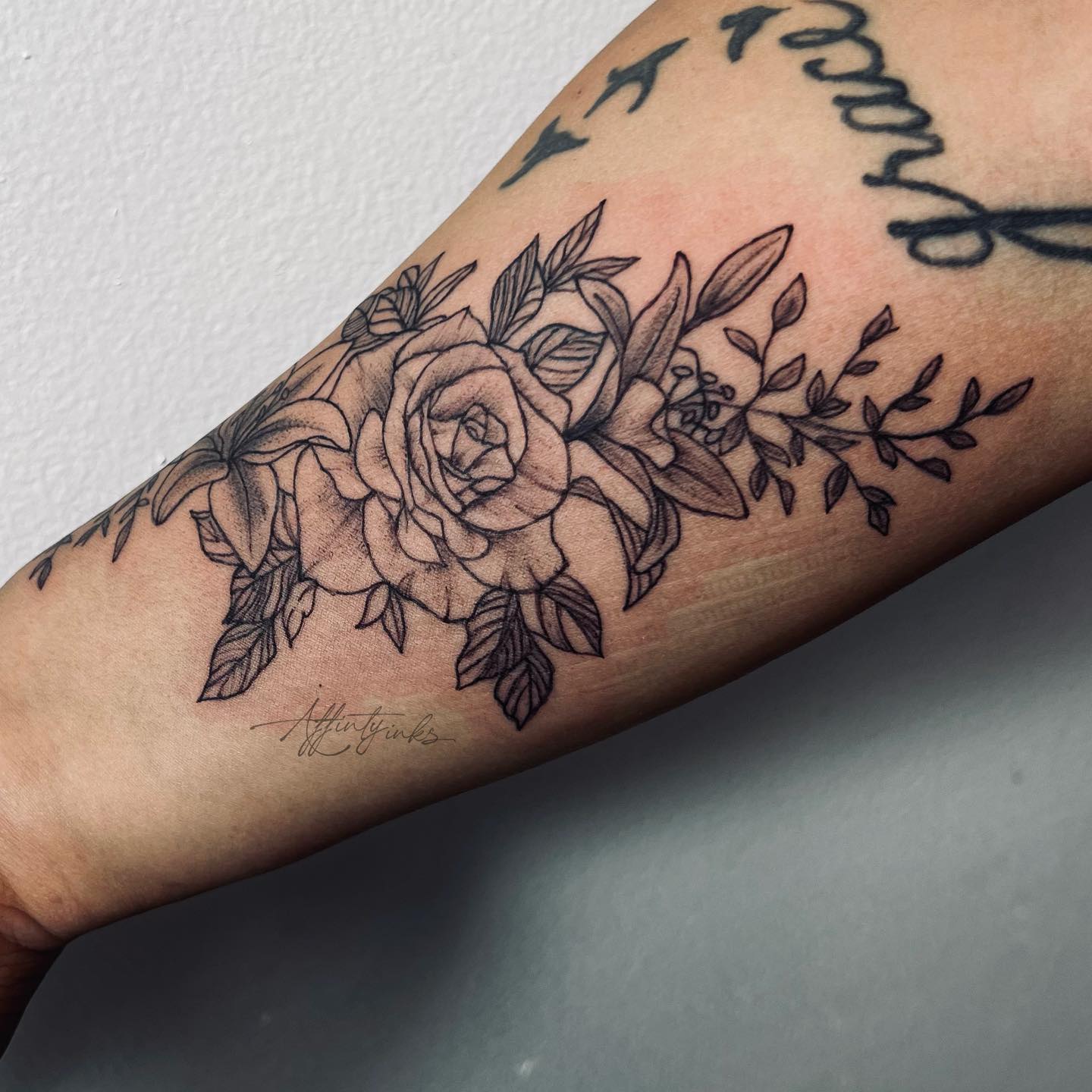 Black rose and lily tattoo with leaves look totally amazing on arm! It is a symbol of a dark and light side of human soul. Also, this tattoo represents the balance between good and evil, life and death. Are you ready to get it?