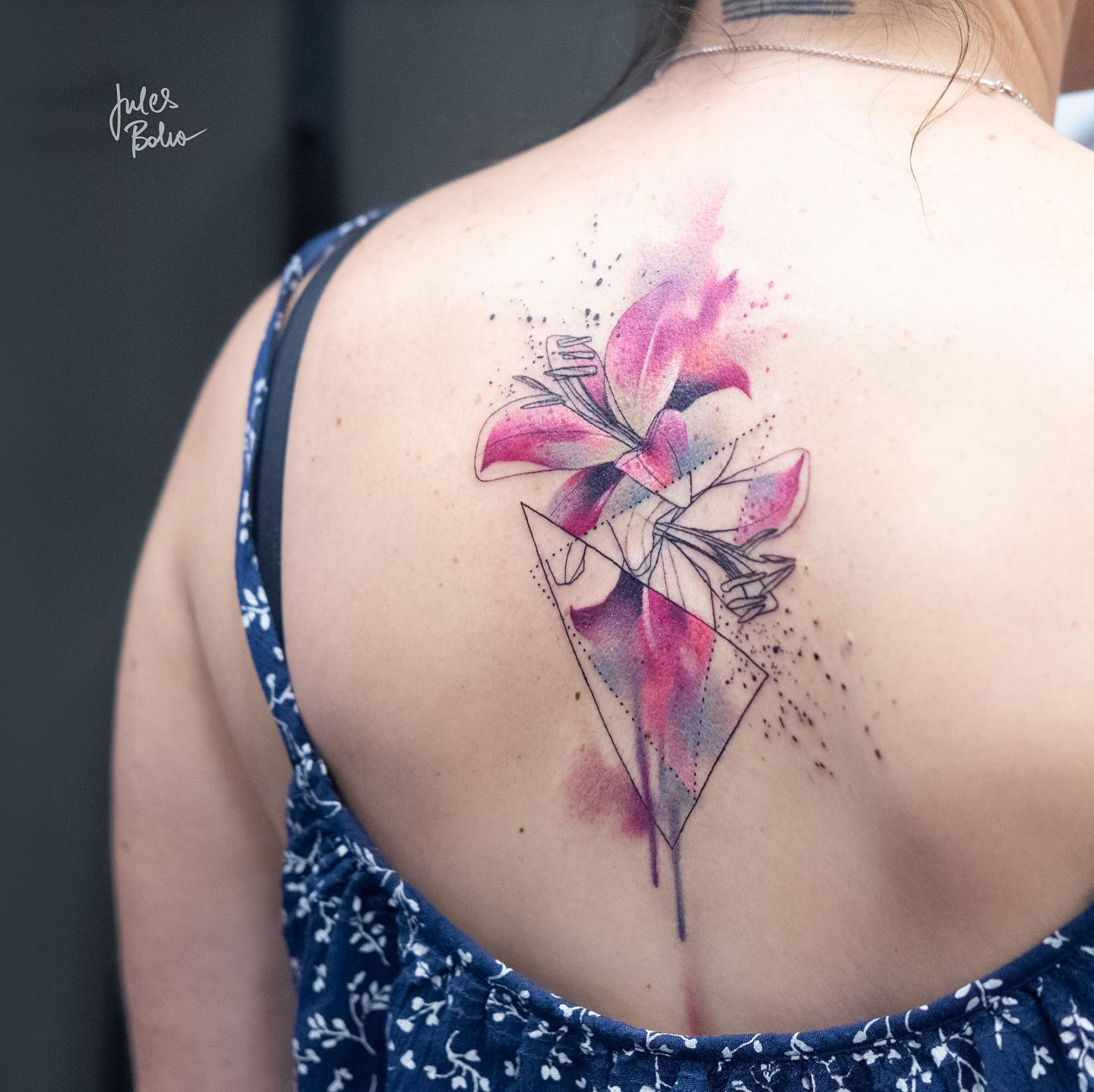 A pink abstract lily tattoo is a great option for anyone who wants to get inked, but doesn't know where to start. The color of the flower is beautiful and feminine, which makes this a great choice for any woman. The abstract style of the flower makes it unique and interesting, too.