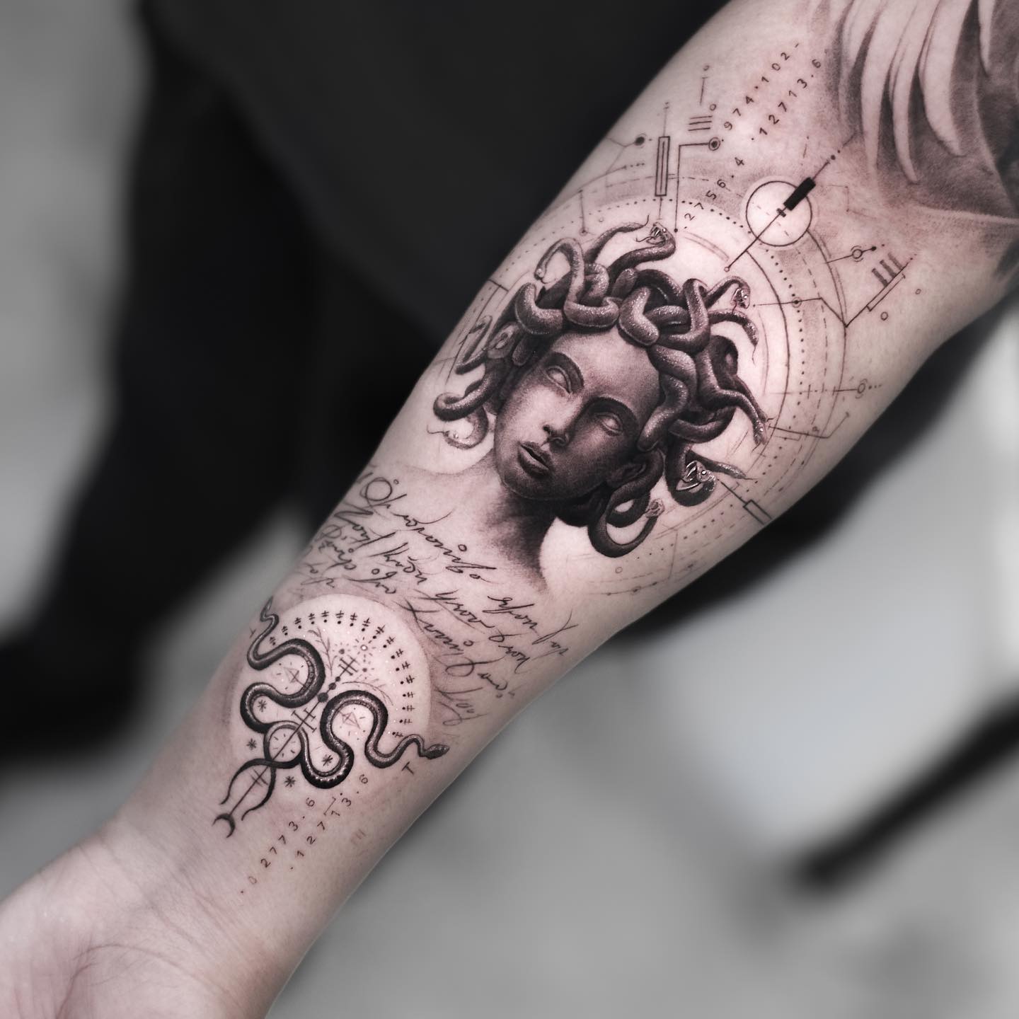 Uniqueness always wins! Your forearm will stand out with a big size Medusa tattoo which is full of small and great details such as words, snakes and geometrical shapes.
