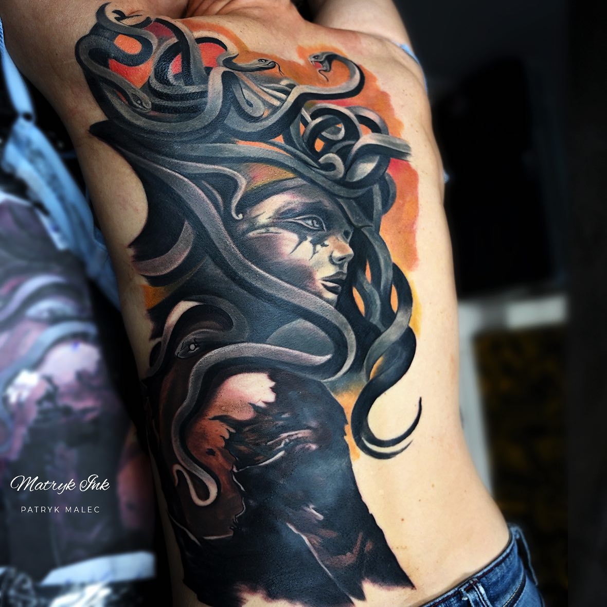 Those who like cover-up tattoos will adore this Medusa tattoo on back. Darker shades of colors take a lot of courage to get on your body, so let's show how bold you are with this.