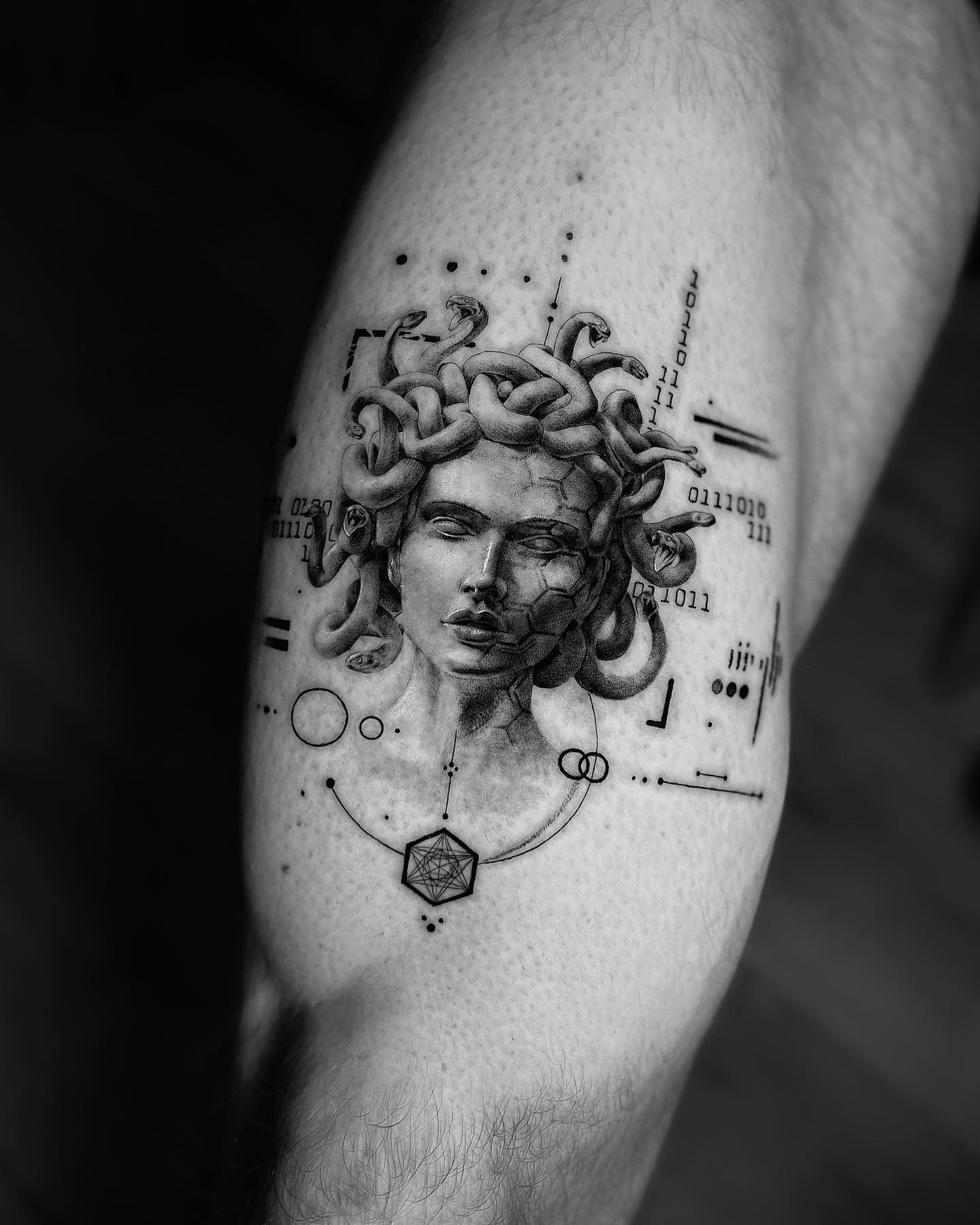 The tattoo above gives a statue feeling, doesn't it? To show your inner strength with a unique Medusa tattoo, this is for you. The hexagons covering the half of Medusa's face, circles and lines look quite mesmerizing. Don't forget that you need to find a talented tattooist to get it.
