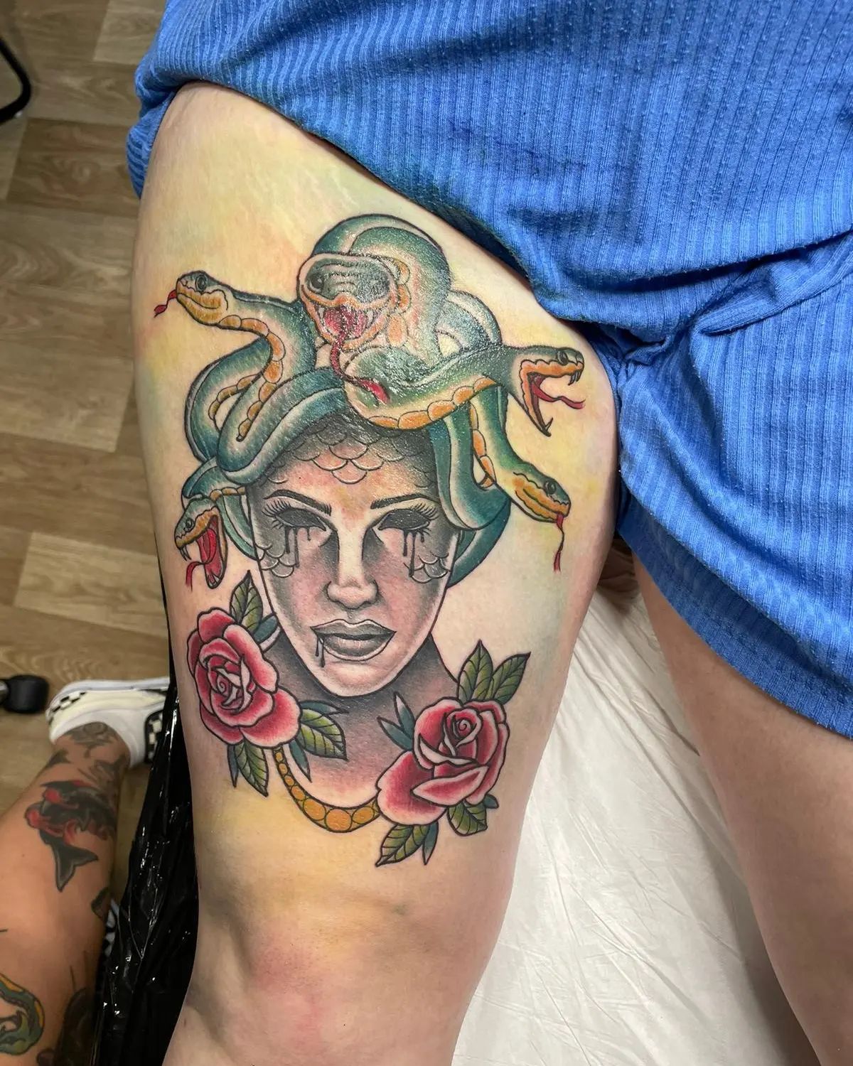 Colorful tattoos offer a look that is absolutely beautiful. Since the colors are strong symbols of different emotions and feelings, you can combine colors in a beautiful Medusa tattoo. In the statue, roses, which are the symbols of romance and courage, are placed under Medusa.