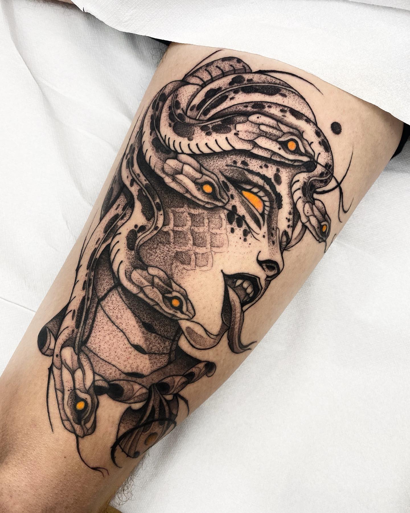 If you want to get a Medusa tattoo that shows her something evil and scary, then this tattoo is definitely for you. In this blackwork tattoo, Medusa's and the snakes' eyes are yellow, which shows a contrast with black. Go and get this tattoo as soon as possible.