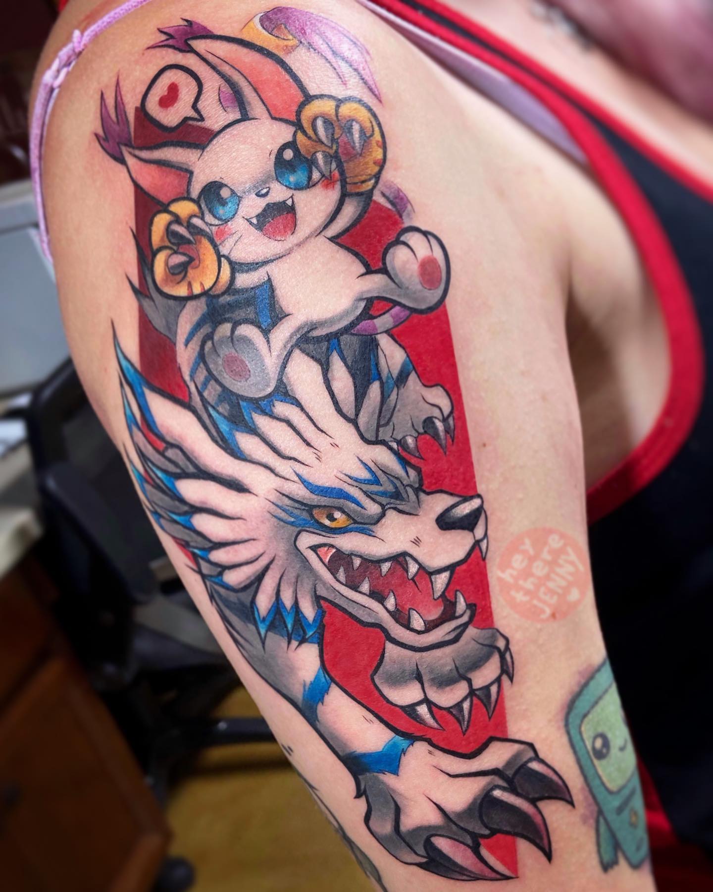 Garurumon and Gatomon are Digimon, which are basically digital monsters. They're also a part of the series that includes Pokemon. They're like the Pokemon equivalent of cats, but they're more like wolves than house cats. Go and get a tattoo of them.