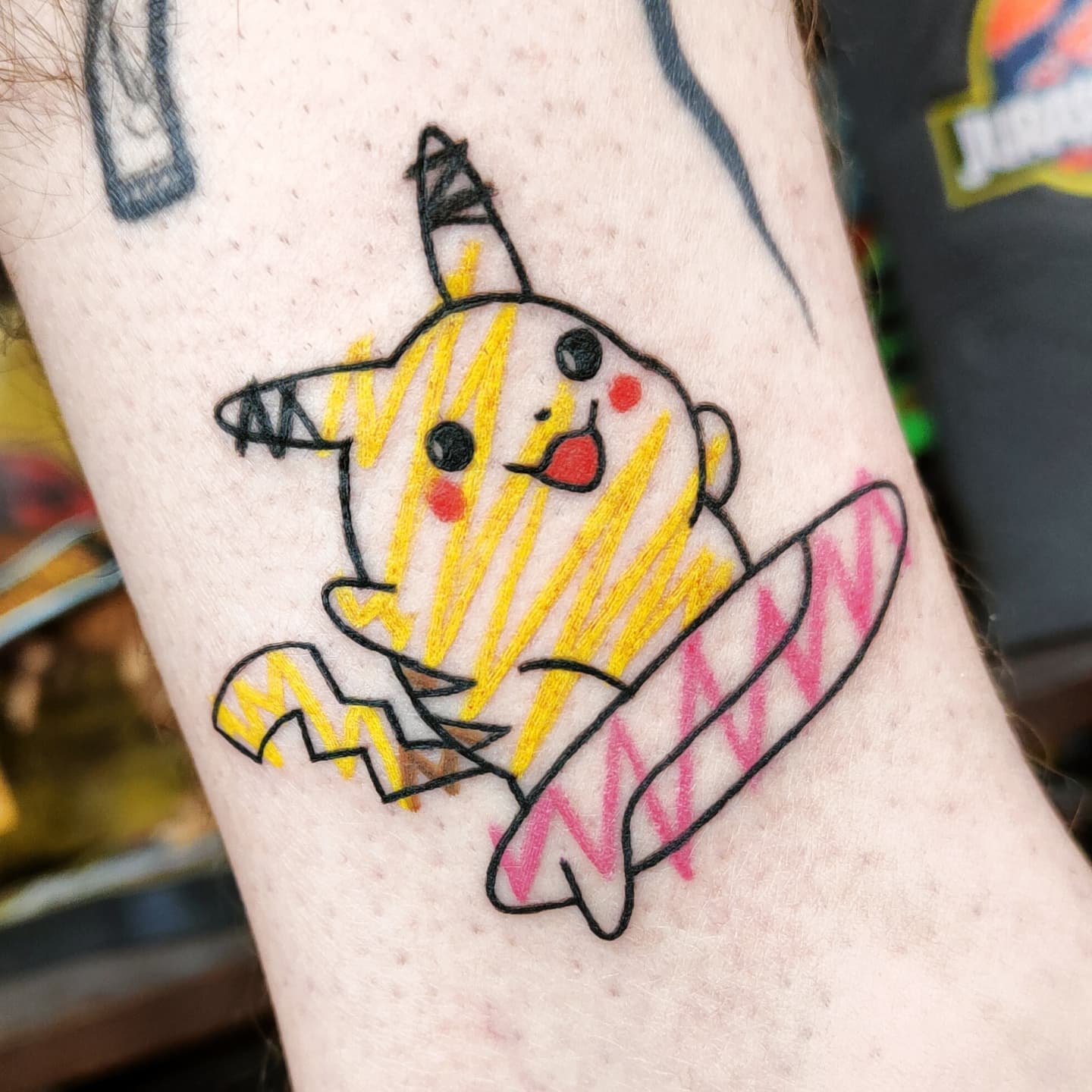 Being a yellow rodent-like creature who can summon electricity, Pikachu is one of the most popular characters of Pokemon, maybe the most popular one. In the tattoo above, a different type of coloring is used and this makes it cuter.