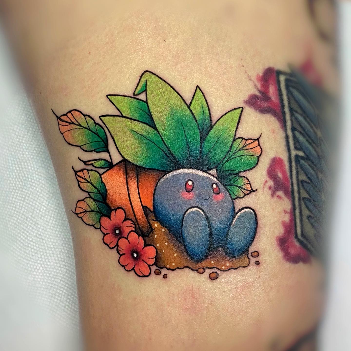 The tattoo above is a grass type pokemon that evolves into gloom and then into vileplume. It has a flower on its head that changes color depending on its mood. Plus, it looks super-cute.