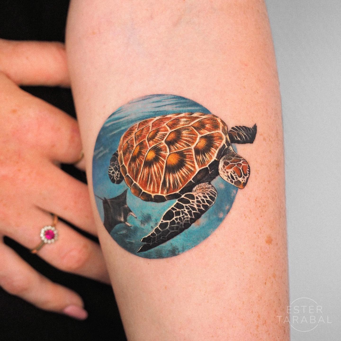 The sea turtle looks so realistic that it feels like it will come to life. The under the sea image is created with a circular tattoo in a great way. By the way, can you spot the stingray fish behind the sea turtle? You should get these beautiful creatures inked on your body.