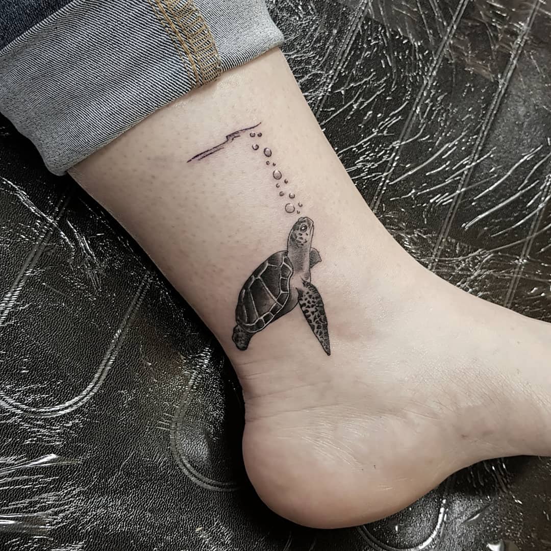 Small sea turtle on ankle sounds fabulous! In this blackwork tattoo, the lines are so precise, and the shading is just right. The way the tattoo artist did the shading on the turtle's shell is so beautiful!