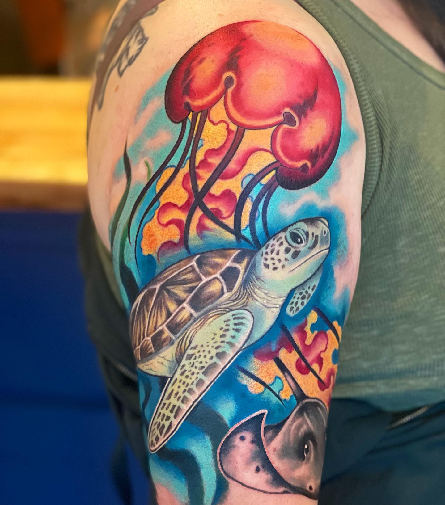 The colorful sea turtle and jelly fish tattoo is very beautiful! I love the combination of the two and how they look together. It's very unique and eye-catching.