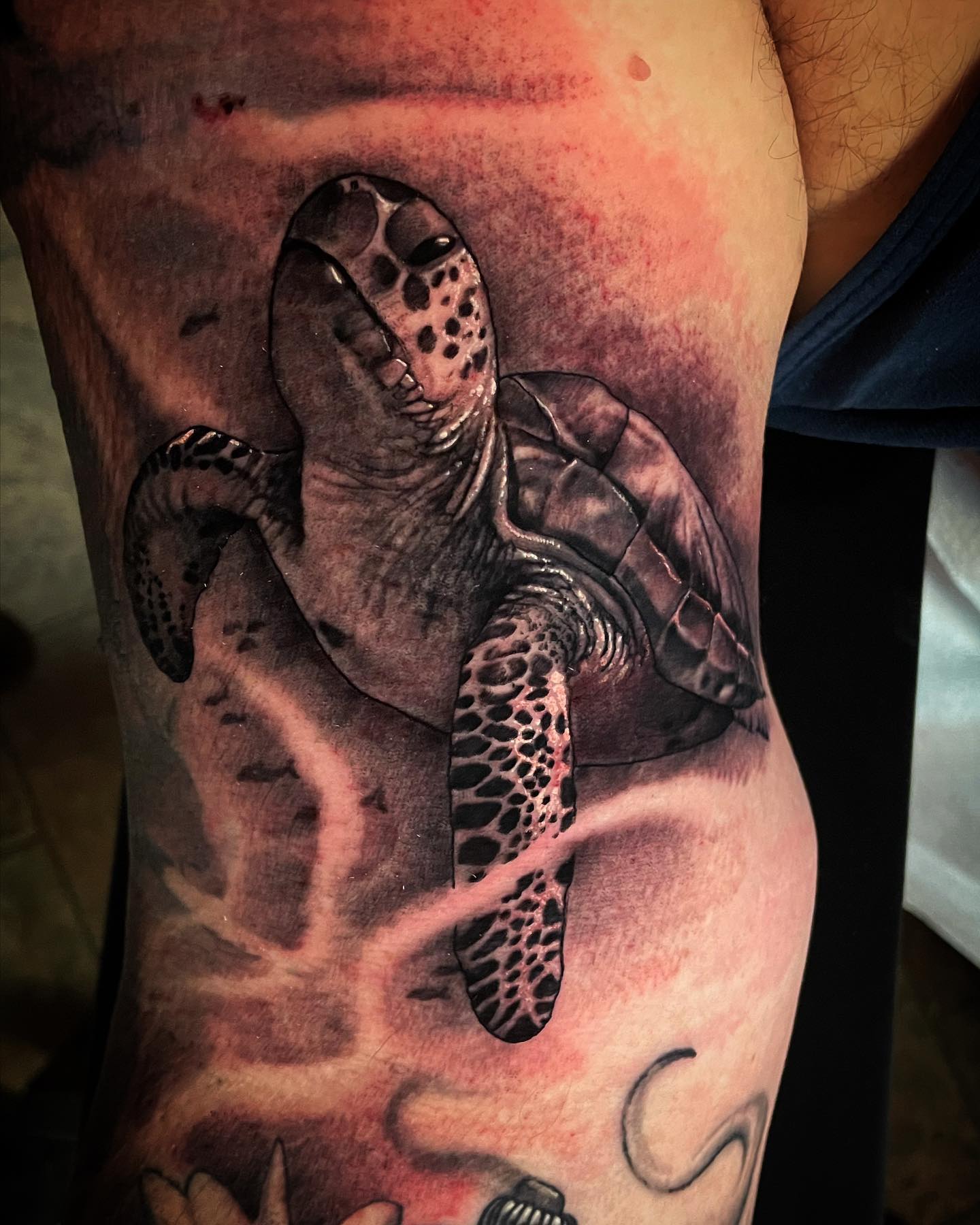 Using the blackwork technique to create a sea turtle tattoo is a nice idea. The shading, in particular, is really impressive. The turtle above looks like it's swimming in an ocean, which is a great way to express your love for water.