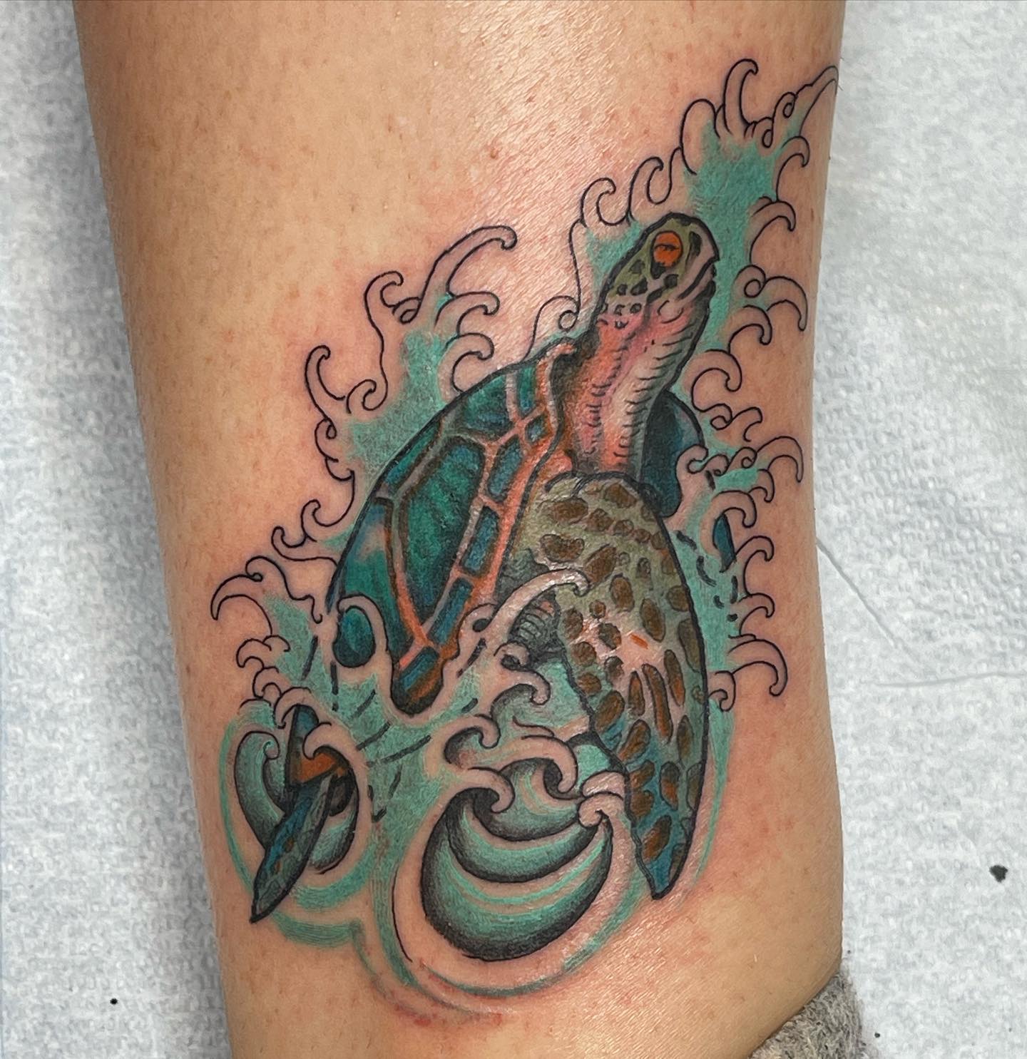 It looks like the sea turtle is coming out of the sea and this whole picture creates a unique look with the movement of sea waves. Turquoise sea waves and all the colors used in this tattoo are ready to make you shine out!