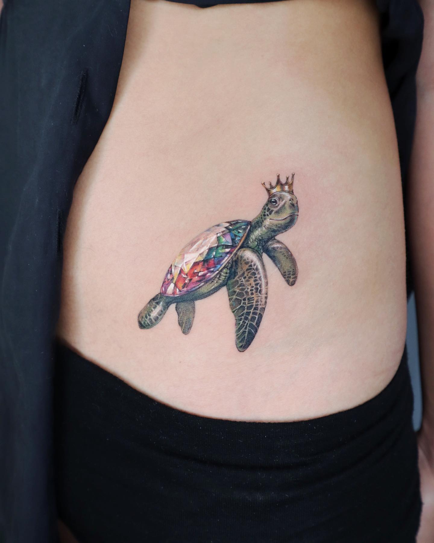 Wanna have a king or queen sea turtle tattoo that looks super-real? If your answer is yes, cover the sea turtle's shell with a gemstone to give it a rich look and put king's crown on its head.