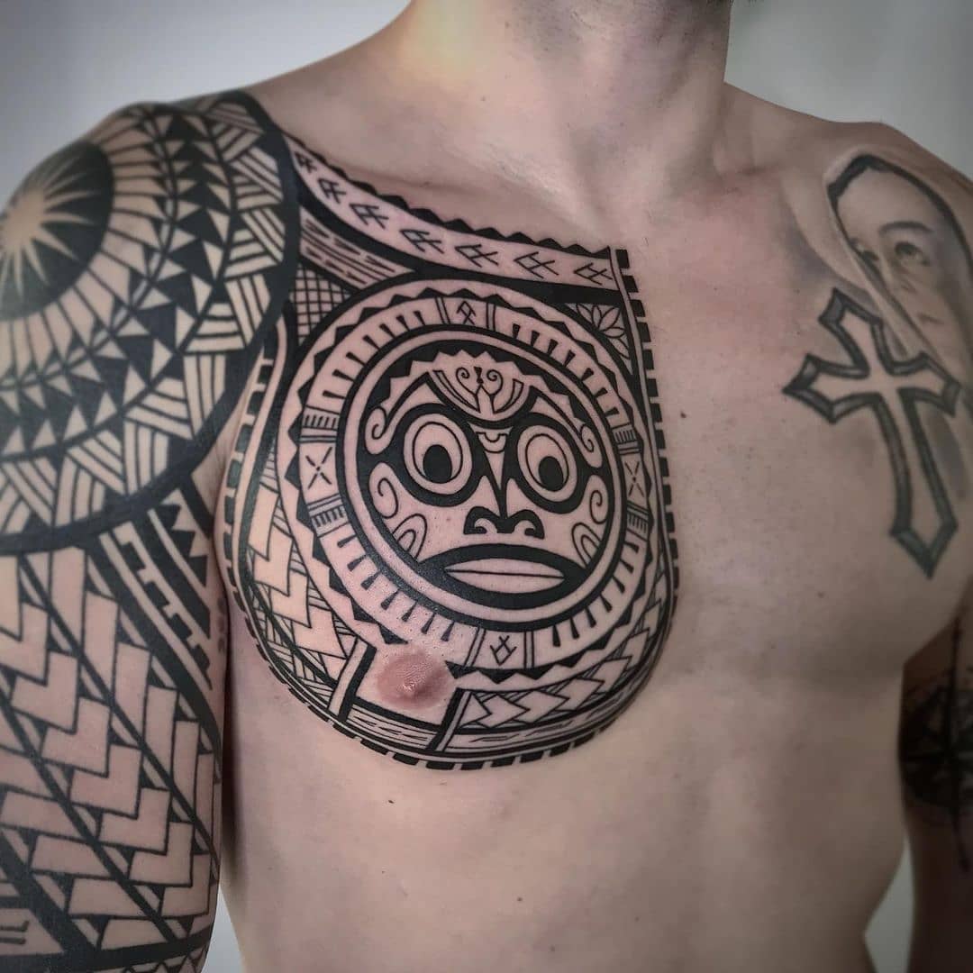 Polynesian style chest and shoulder tattoo