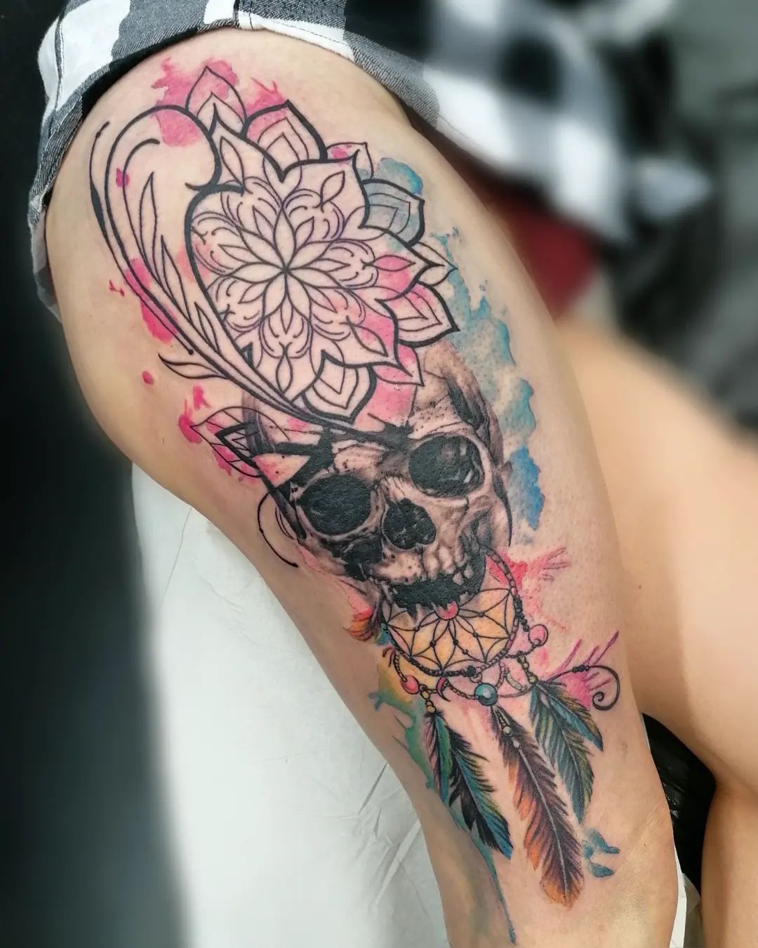 The Dream Catcher with a skull tattoo is just one different version of this ancient symbol—and it can be seen as a way to honor or commemorate someone who has passed away. The colors and the water color splash look fabulous.