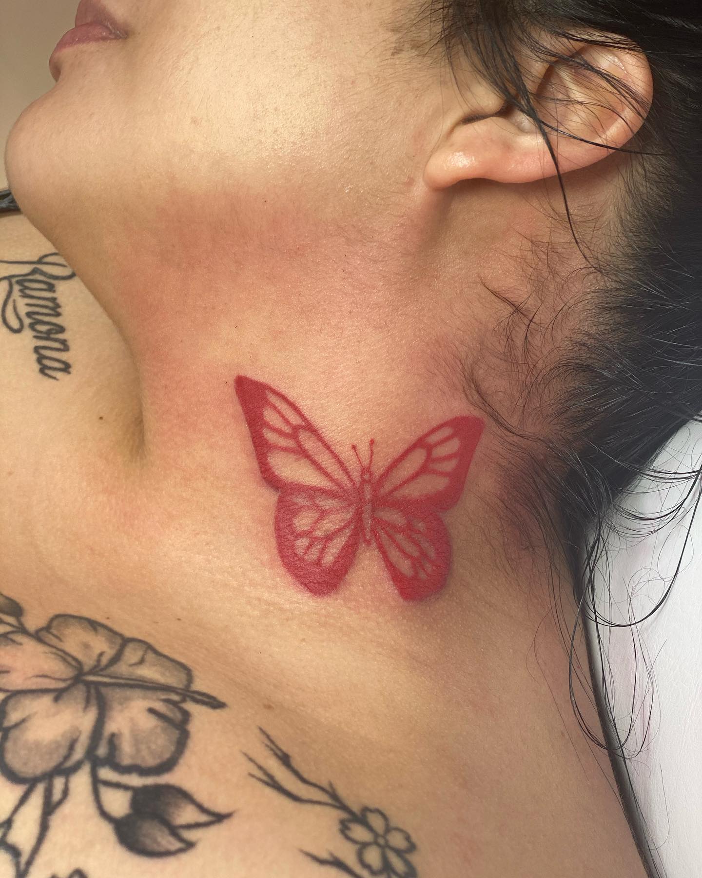 Red butterfly neck tattoo female