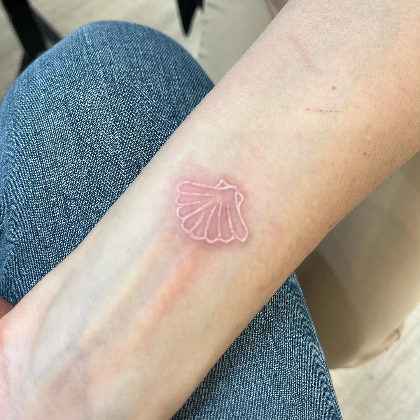 A white ink sea shell tattoo is a great way to show your love for the sea and all it has to offer. You can get the design inked on your body, in the shape of an actual shell, or you can have it done with just a few simple lines that mimic the shape of an actual shell, like the one above.