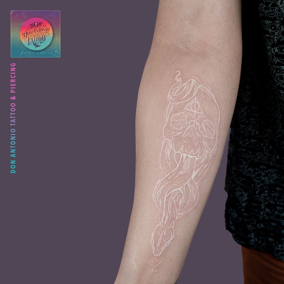 White ink Death Eater tattoo is a great way to show your love for the dark side. It's subtle and stylish, so you don't have to worry about wearing it in public. The white ink really makes the design pop, and the placement is perfect.