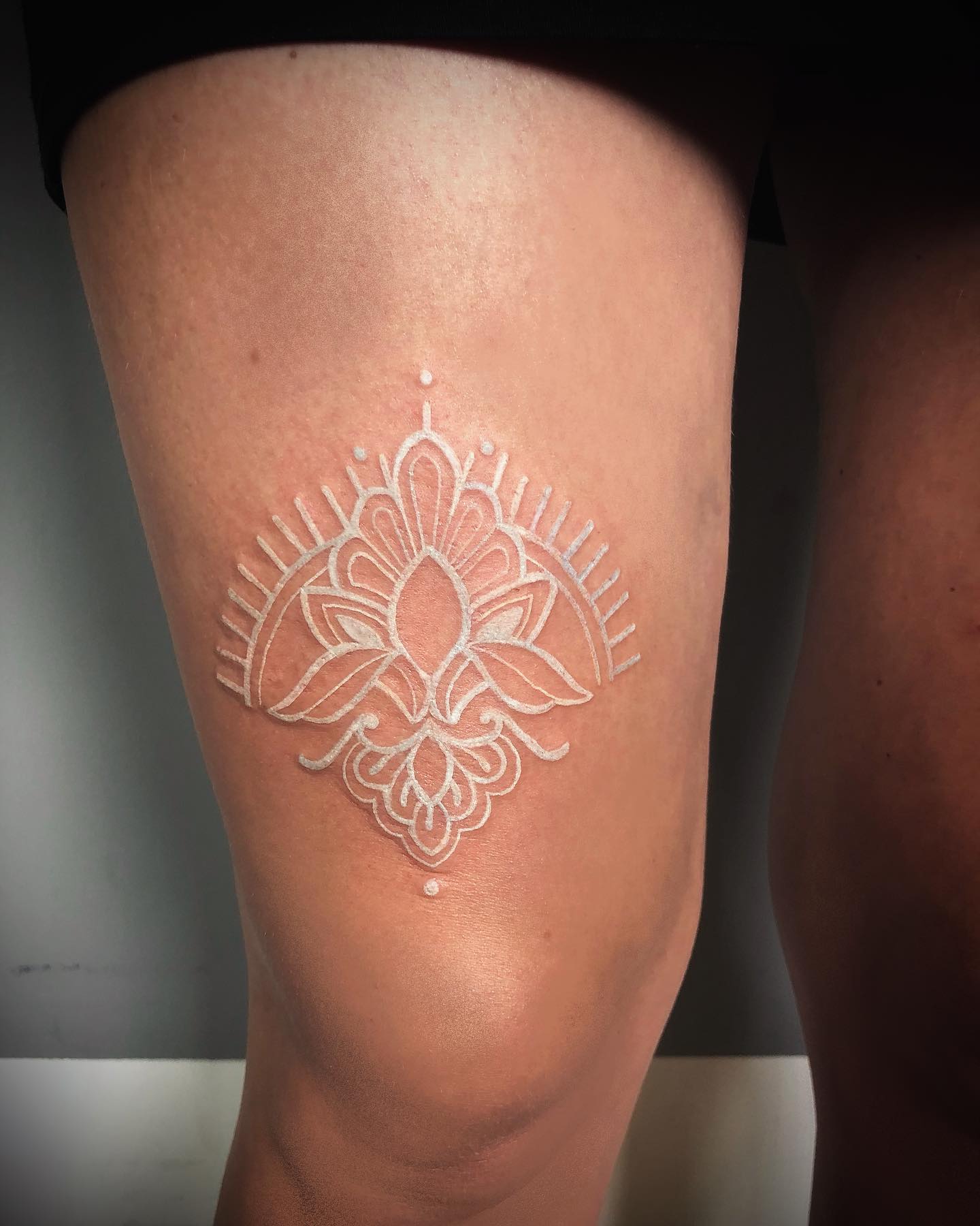 An ornamental tattoo is like jewelry for your skin. It's an accessory that can be used to express your personality and tell a story about who you are, or how you want people to see you. A white ornamental tattoo on your upper leg will make you stand out, are you ready for it?