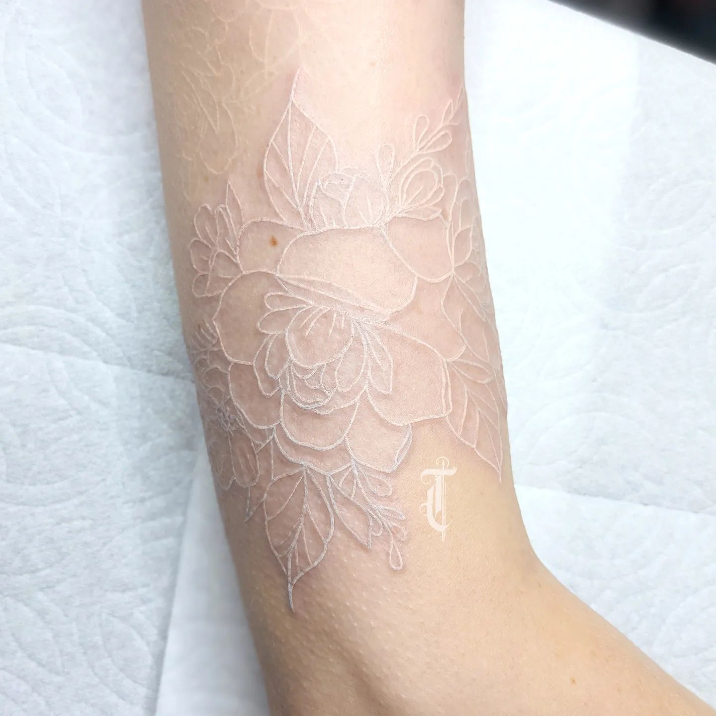 Wanna be different and show contrast between imagination and reality? If your answer is yes, why not getting a white ink rose tattoo? The contrast between the white ink and the red of the rose is great. It works well with your skin tone, too.