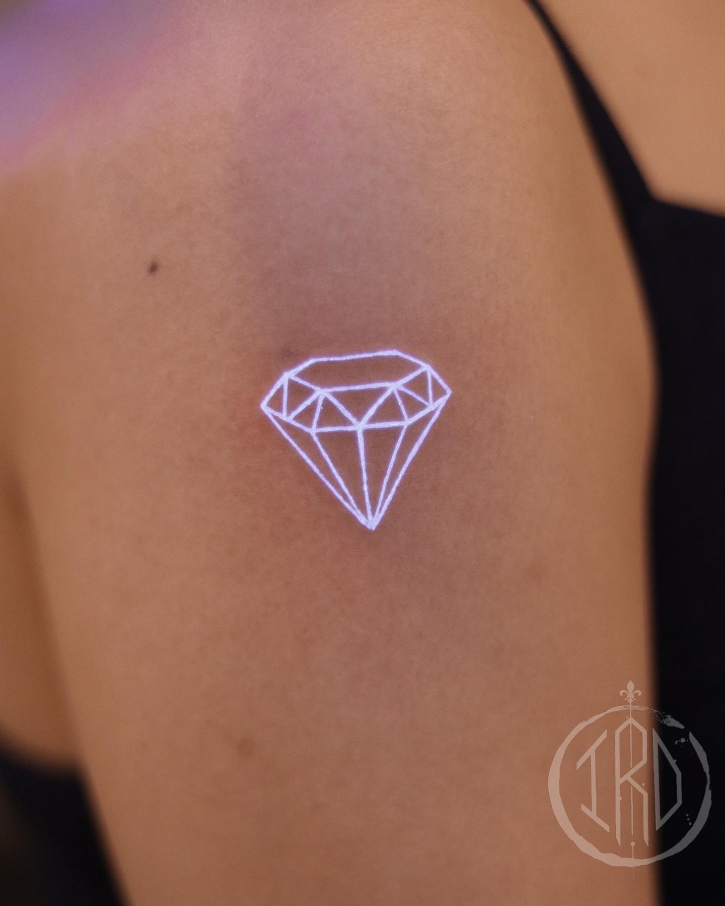 The white ink diamond tattoo looks like it could be a small diamond or star shape. The point of this tattoo is to put the focus on your skin and how it glows. The white ink will shine through your skin and create a bright glow.