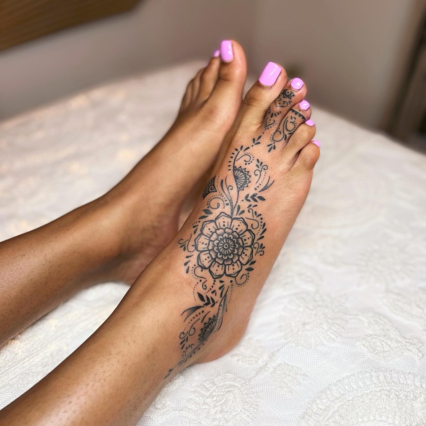 Minimalist daisy tattoo on the ankle